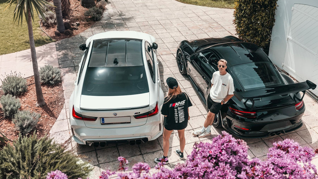 NoHalfSends Summer Sale — BMW M3 Touring and Porsche GT3 RS in a sunlit driveway